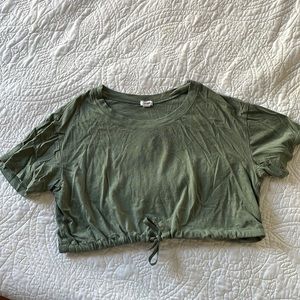Dark green tied crop top, gym/workout shirt.